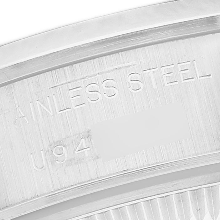 The image shows a close-up of the case back edge with the engraving "STAINLESS STEEL" on a Rolex Date 69160 Women's Stainless Steel White Dial 69160 Women's Stainless Steel White Dial model watch.