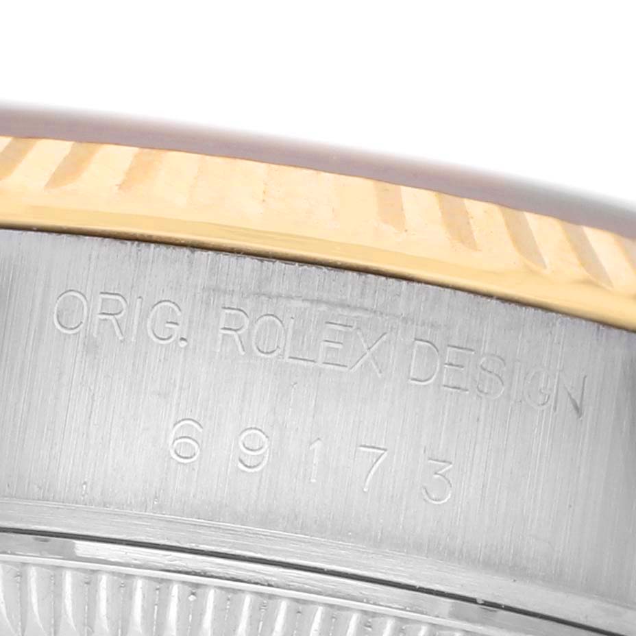 The image shows a close-up of the side of the Rolex Datejust 69173 Women's Steel and Gold (two tone) Champagne Dial, highlighting the engraved case and part of the bezel.