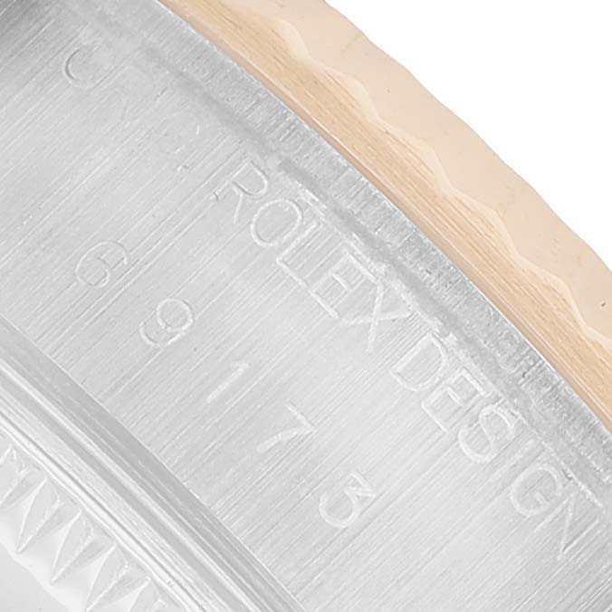 The image shows a close-up of the engraved side of the bezel on a Rolex Datejust 69173 Men's Steel and Gold (two tone) Champagne Dial watch.