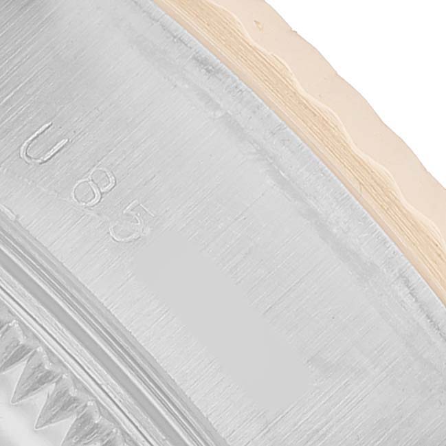 The image shows a close-up of the Rolex Datejust 69173 Men's Steel and Gold (two tone) Champagne Dial watch case edge, displaying part of the bezel and engraved markings.