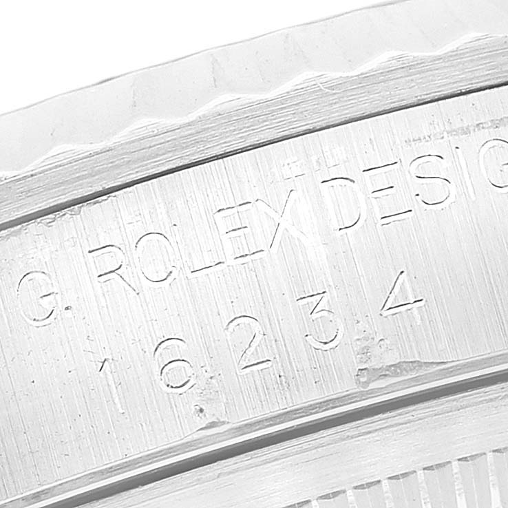 The image shows an engraved part of the case back ring of a Rolex Datejust 16234 Men's Stainless Steel Silver Dial 16234 Men's Stainless Steel Silver Dial watch at a close-up angle.