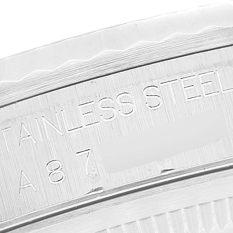 This image shows a close-up of the engraved text on the stainless steel case back edge of a Rolex Datejust 16234 Men's Stainless Steel Silver Dial 16234 Men's Stainless Steel Silver Dial watch.