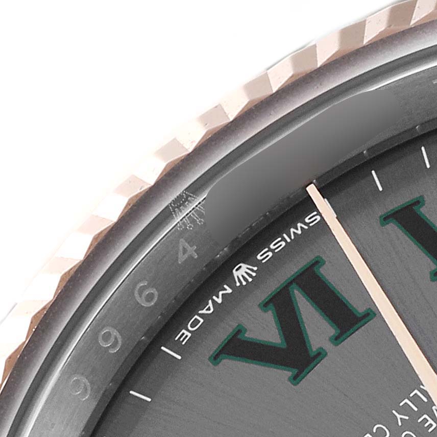 The image shows a close-up of the Rolex Datejust 126231 Men's Steel and Gold (two tone) Grey Dial 126231 Men's Steel and Gold (two tone) Grey Dial watch, featuring part of its fluted bezel and dial with the "Swiss Made" text.