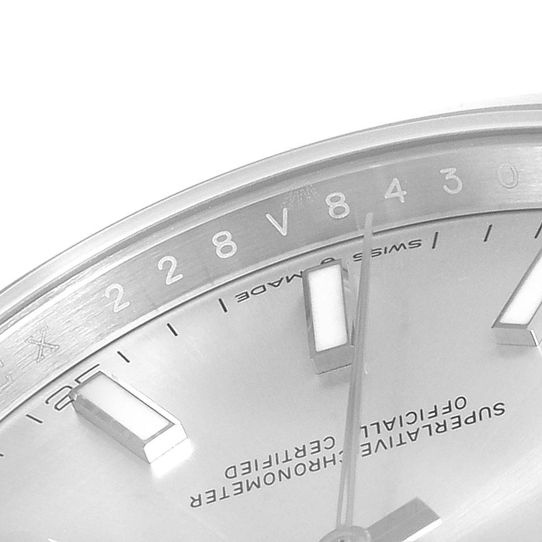 This image shows a close-up of the Rolex Datejust 41 126300 Men
s Stainless Steel Silver Dial 126300 Men
s Stainless Steel Silver Dial
s dial, bezel, and part of its indices and hands.
