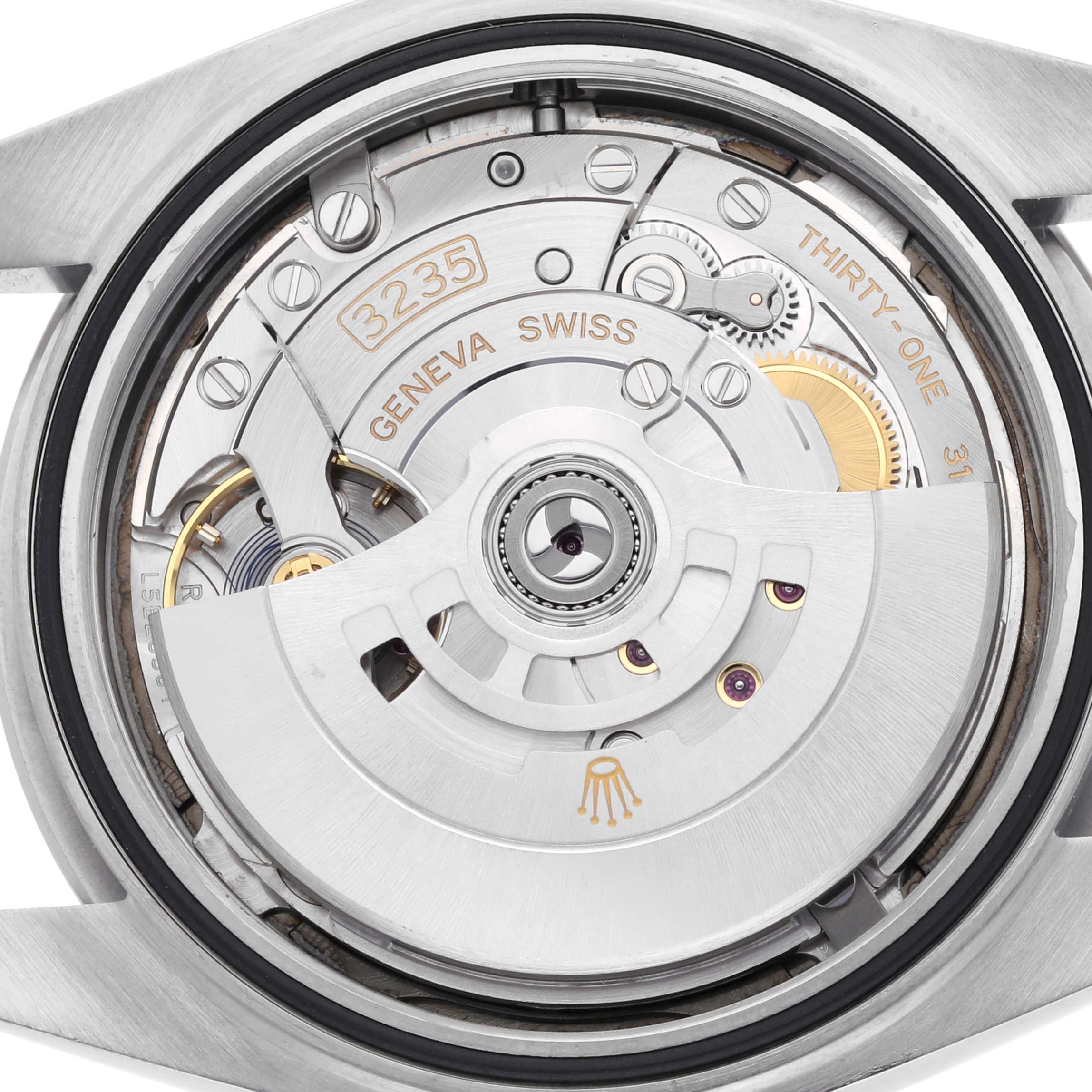 The image shows the movement of a Rolex Datejust 41 126300 Men
s Stainless Steel Grey Dial 126300 Men
s Stainless Steel Grey Dial watch, viewed from the back, highlighting the rotor and intricate mechanics.