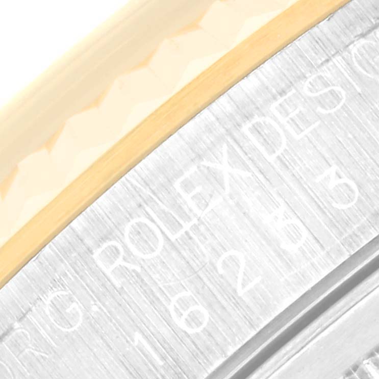 This image shows a close-up of the engraved bezel edge of a Rolex Datejust 16233 Men's Steel and Gold (two tone) Champagne Dial 16233 Men's Steel and Gold (two tone) Champagne Dial watch.