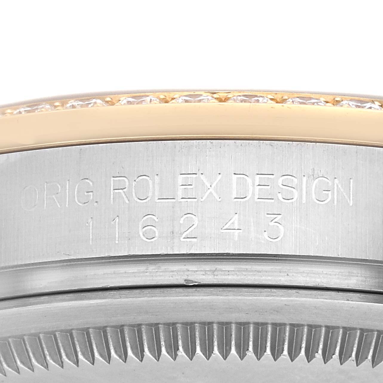 The image shows a close-up of the bezel and serial number engraving on a Rolex Datejust 116243 Men's Steel and Gold (two tone) Champagne Dial 116243 Men's Steel and Gold (two tone) Champagne Dial watch.