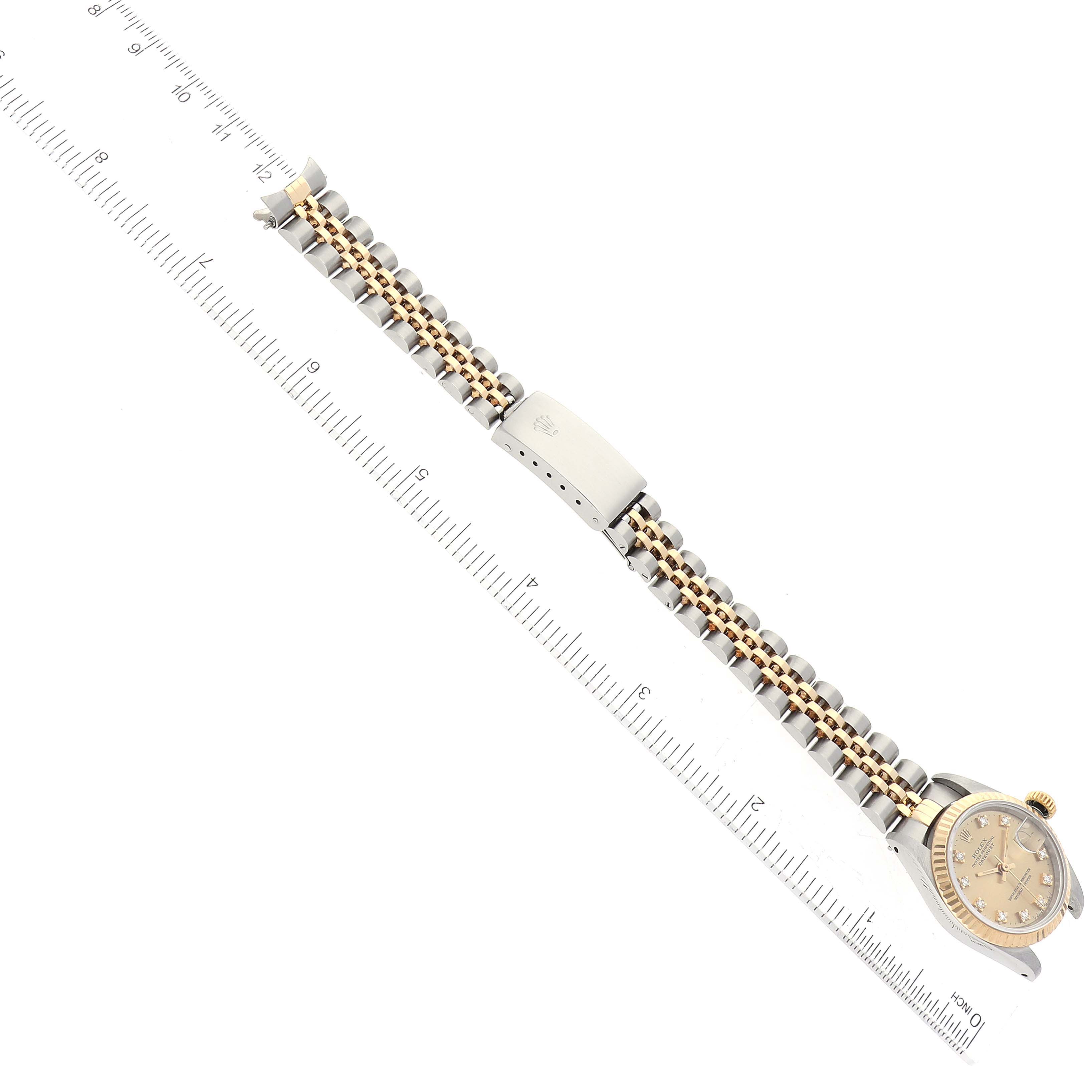 The image shows a Rolex Datejust 69173G Women's Steel and Gold (two tone) Champagne Dial 69173G Women's Steel and Gold (two tone) Champagne Dial watch placed horizontally with the dial and complete bracelet visible alongside a ruler.