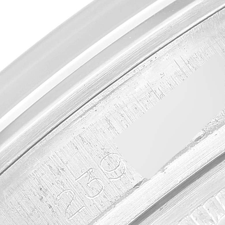 This close-up image shows the engraved serial number on the edge of a Rolex Vintage Collection 1600 Men's Stainless Steel Silver Dial 1600 Men's Stainless Steel Silver Dial watch.