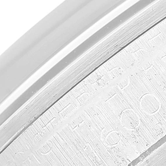 This image shows a close-up of the engraved edge detail on the Rolex Vintage Collection 1600 Men's Stainless Steel Silver Dial 1600 Men's Stainless Steel Silver Dial watch.