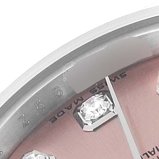 This close-up image of a Rolex Datejust 179174 Women's Stainless Steel Pink Dial 179174 Women's Stainless Steel Pink Dial watch shows part of the dial with diamond hour markers and the "Swiss Made" engraving on the inner bezel.