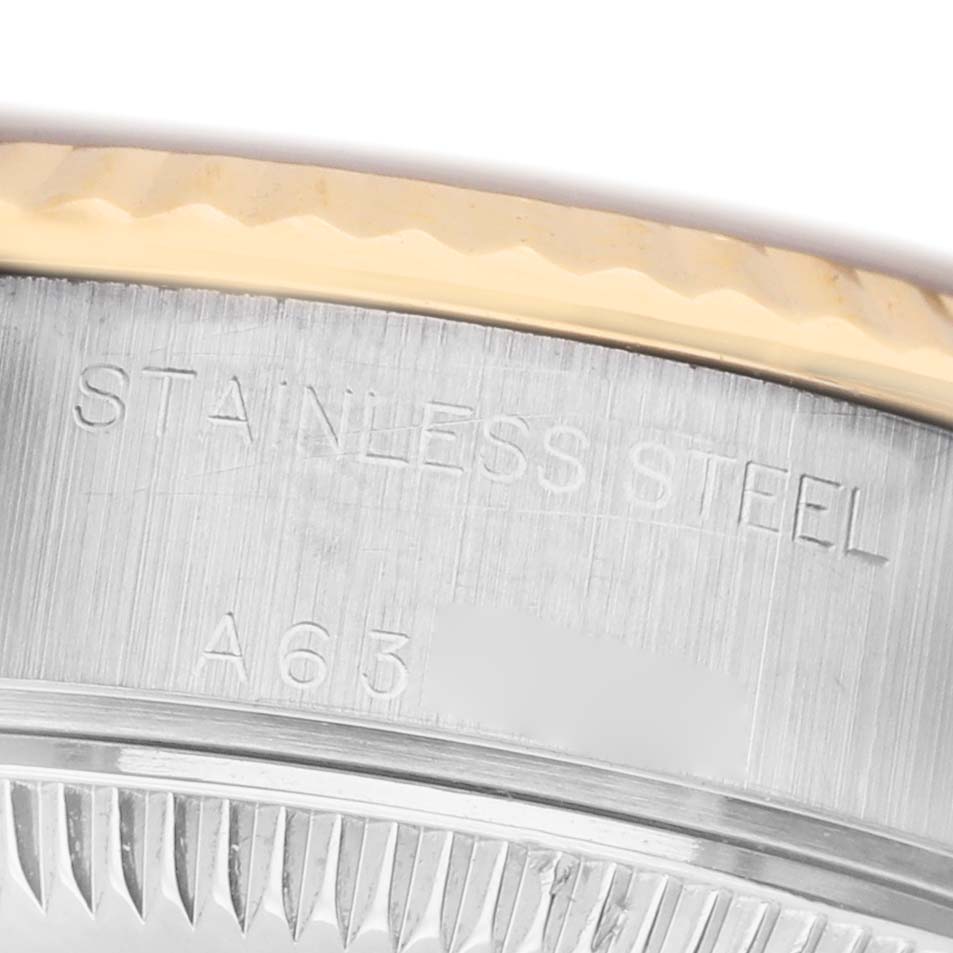 The image shows a close-up of the stainless steel casing with markings on the Rolex Datejust 79173 Women's Steel and Gold (two tone) Champagne Dial watch.