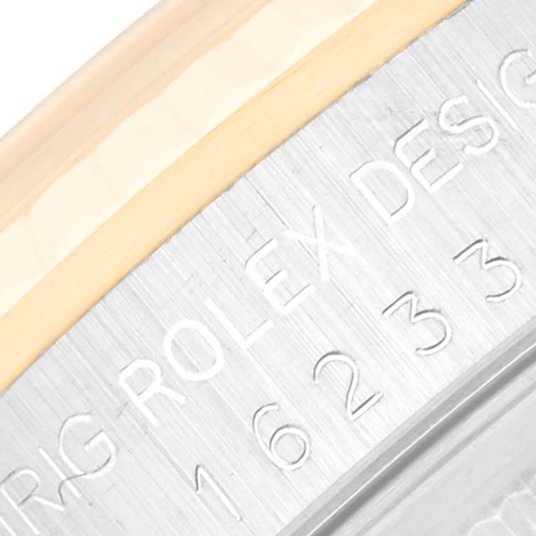 The image shows a close-up of the Rolex Datejust 16233 Men's Steel and Gold (two tone) Champagne Dial 16233 Men's Steel and Gold (two tone) Champagne Dial model's serial number engraving on its case.