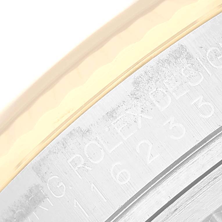 This close-up image shows part of the bezel and the rehaut with engravings of a Rolex Datejust 116233 Men's Steel and Gold (two tone) Beige Dial 116233 Men's Steel and Gold (two tone) Beige Dial watch.