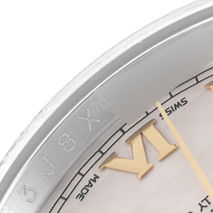 This close-up image showcases a portion of the dial and bezel of a Rolex Datejust 116233 Men's Steel and Gold (two tone) Beige Dial 116233 Men's Steel and Gold (two tone) Beige Dial watch, including the Roman numeral and "Swiss Made".