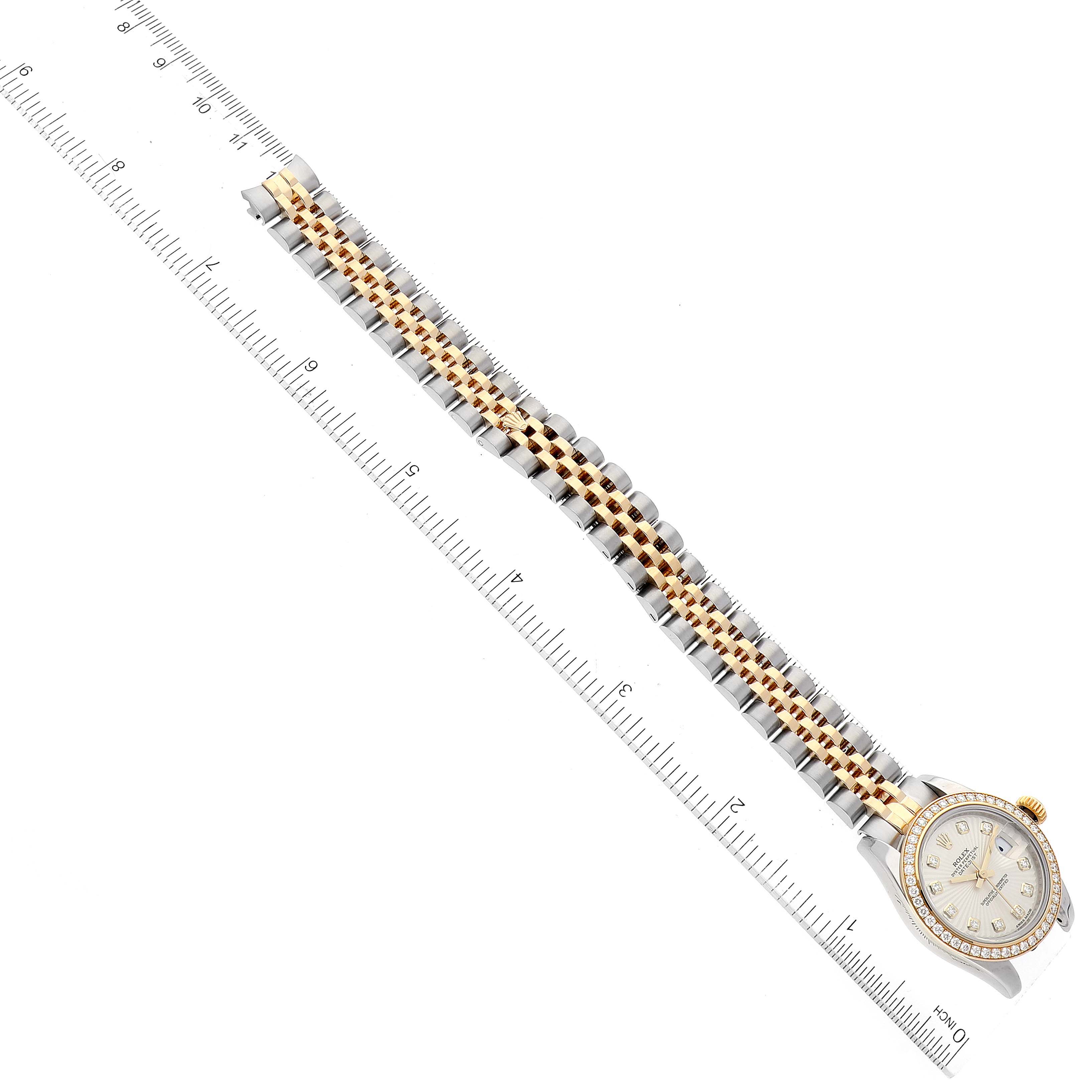 The image shows a Rolex Datejust 179383 Women's Steel and Gold (two tone) Silver Dial 179383 Women's Steel and Gold (two tone) Silver Dial watch placed diagonally next to a ruler, highlighting its bracelet and bezel.