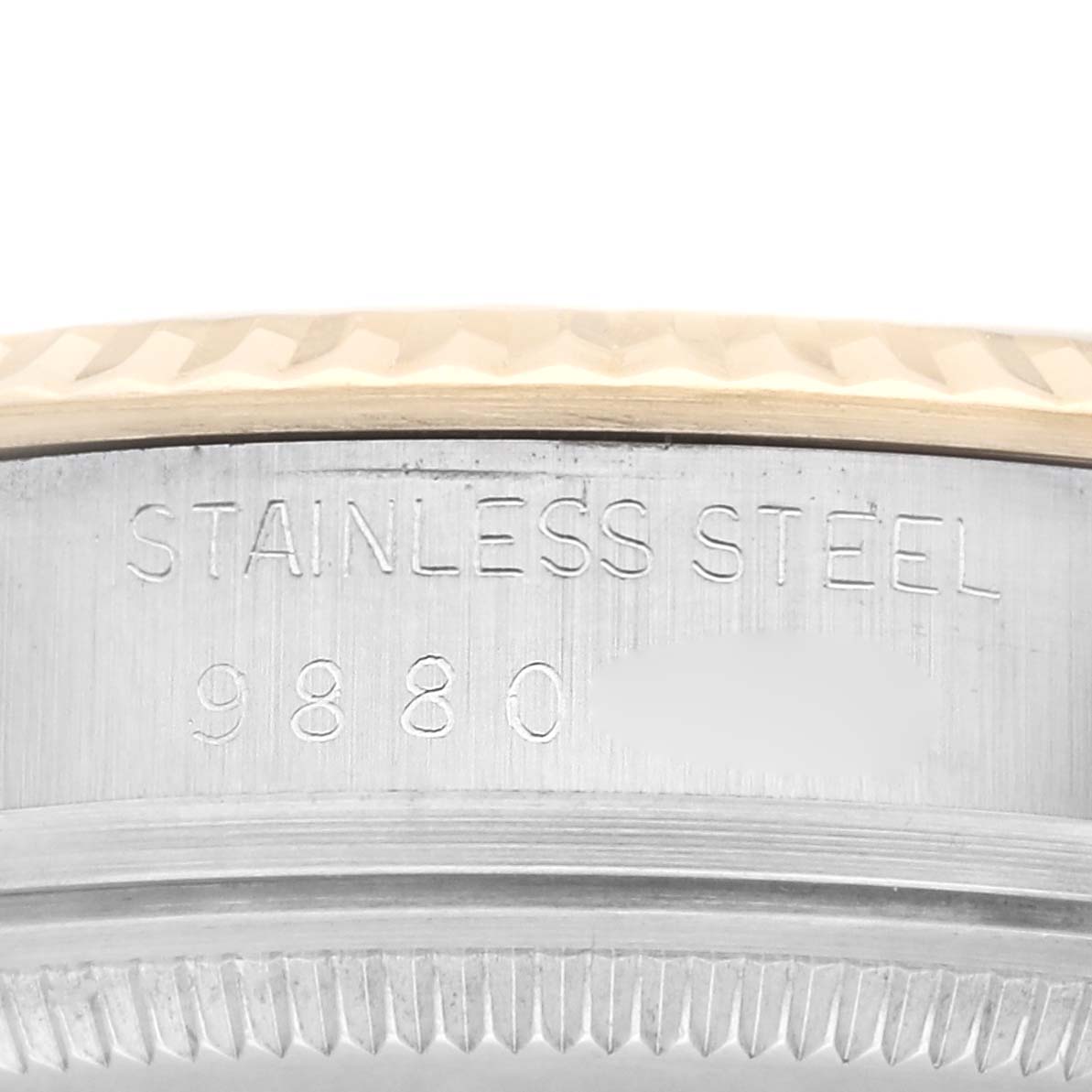 This image shows a close-up of the side of a Rolex Vintage Collection 16013 Men's Steel and Gold (two tone) Champagne Dial 16013 Men's Steel and Gold (two tone) Champagne Dial watch, highlighting the case's stainless steel engraving and serial number.