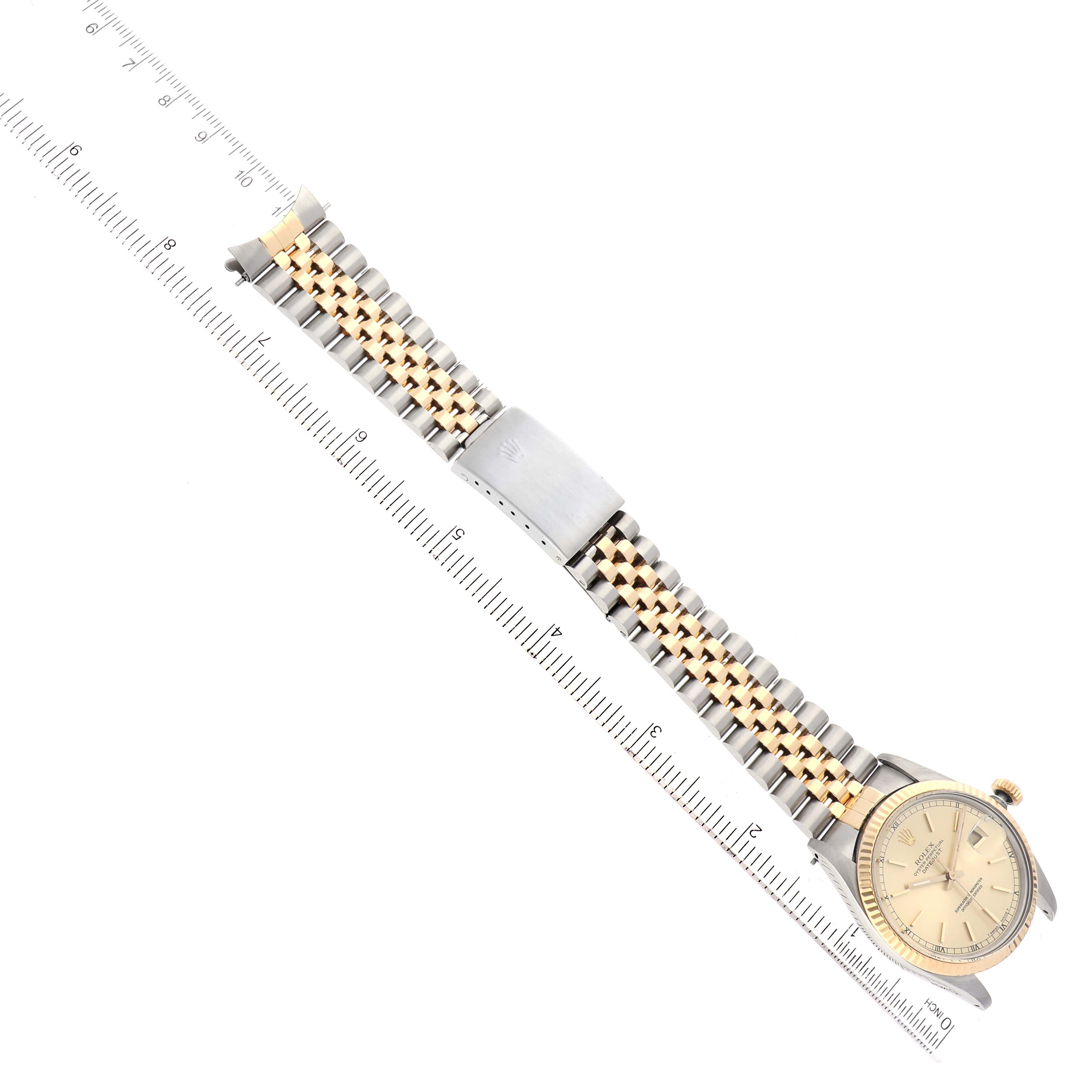 A top-down view of the Rolex Vintage Collection 16013 Men's Steel and Gold (two tone) Champagne Dial 16013 Men's Steel and Gold (two tone) Champagne Dial watch, showing its dial, crown, and two-tone bracelet alongside a transparent ruler.