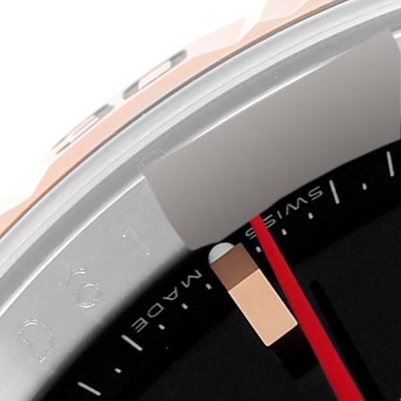 This close-up image of the Rolex Turn-o-Graph 116261 Men
s Steel and Gold (two tone) Black Dial 116261 Men
s Steel and Gold (two tone) Black Dial watch shows part of the dial, the red seconds hand, and a section of the bezel.