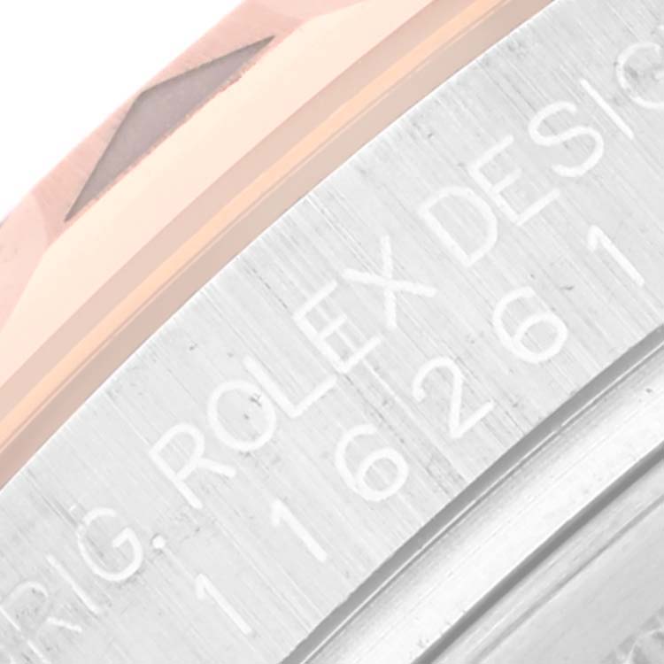 The image shows a close-up of the side view of the Rolex Turn-o-Graph 116261 Men
s Steel and Gold (two tone) Black Dial 116261 Men
s Steel and Gold (two tone) Black Dial watch, highlighting the engraved serial number and design details.