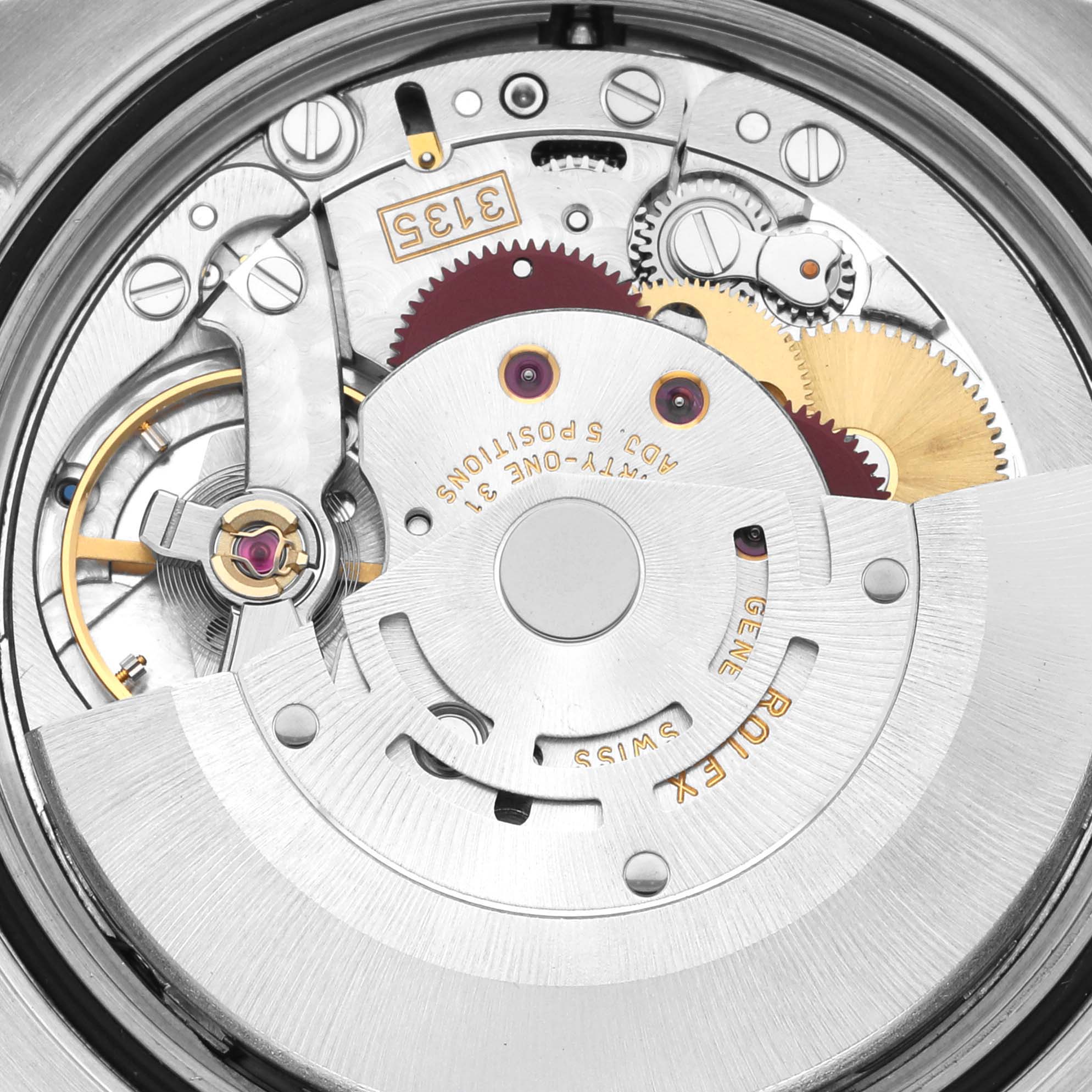 The image shows the internal mechanism of a Rolex Turn-o-Graph 116261 Men's Steel and Gold (two tone) Silver Dial 116261 Men's Steel and Gold (two tone) Silver Dial watch, focusing on the intricate gears and components.