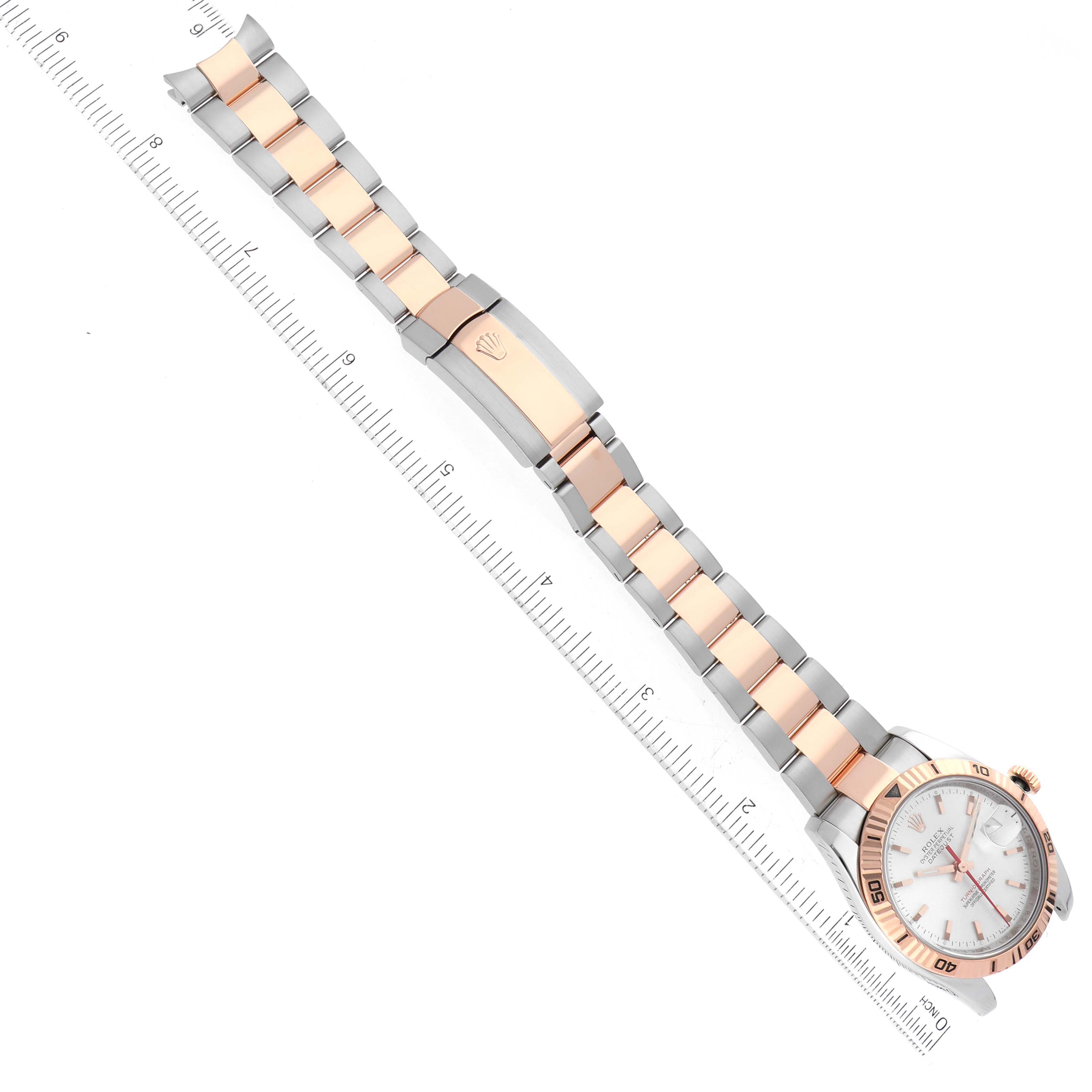 The Rolex Turn-o-Graph 116261 Men's Steel and Gold (two tone) Silver Dial 116261 Men's Steel and Gold (two tone) Silver Dial watch is shown at an angle, highlighting its bracelet, clasp, and part of the bezel with a measuring scale.