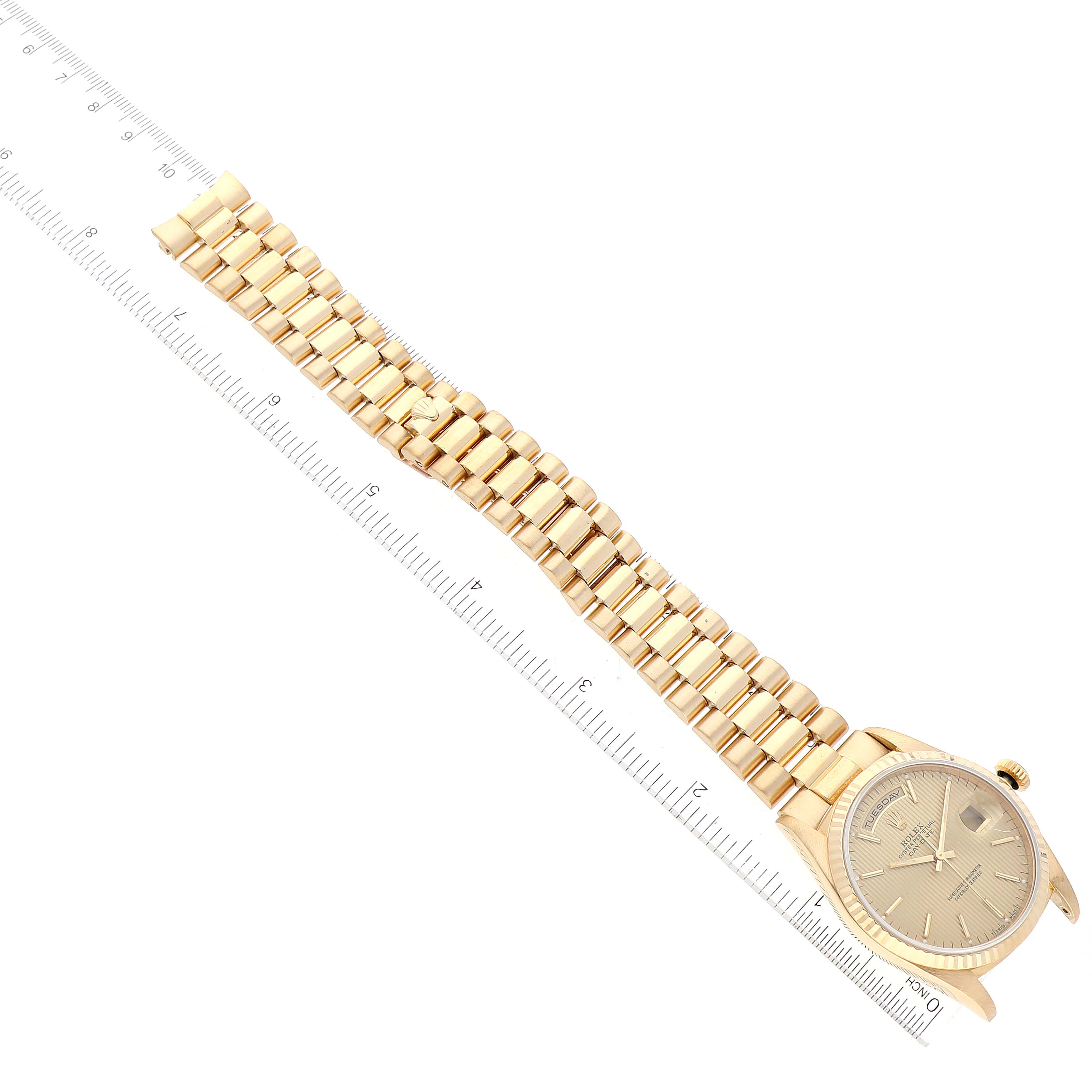 The image shows a gold Rolex President 18238 Men
s Yellow Gold Champagne Dial 18238 Men
s Yellow Gold Champagne Dial model watch with the full bracelet, laid out flat next to a ruler for scale.
