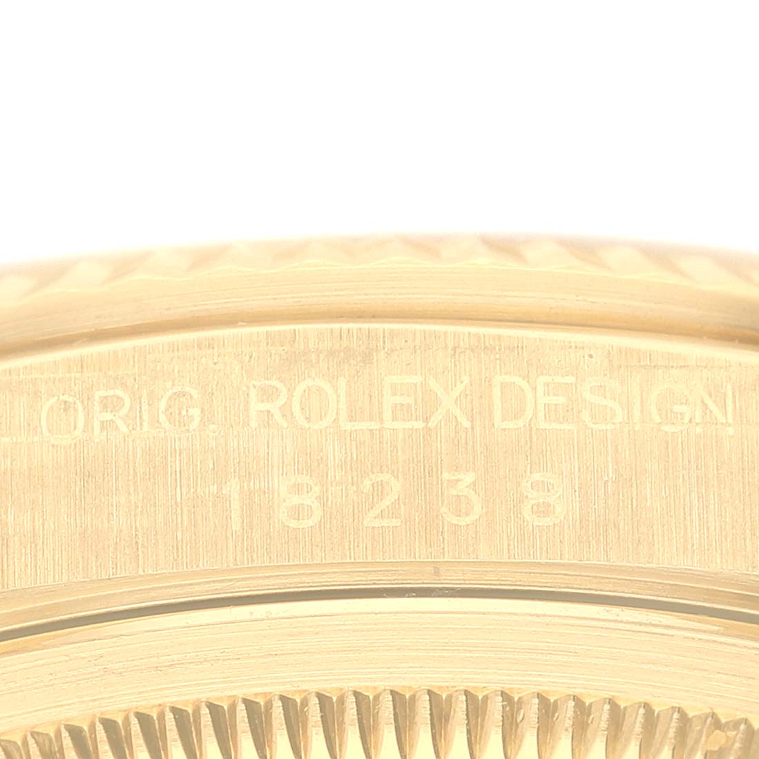 The image shows a close-up of the Rolex President 18238 Men
s Yellow Gold Champagne Dial 18238 Men
s Yellow Gold Champagne Dial model
s case back and the engraved serial number.
