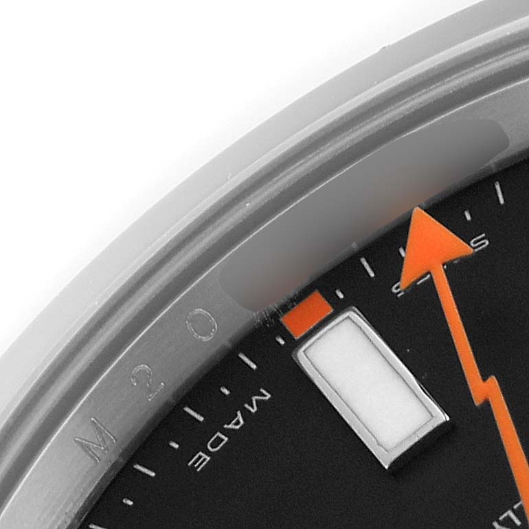 The image shows a close-up of the dial of a Rolex Milgauss 116400 Men's Stainless Steel Black Dial 116400 Men's Stainless Steel Black Dial watch, including part of the orange seconds hand and hour markers.