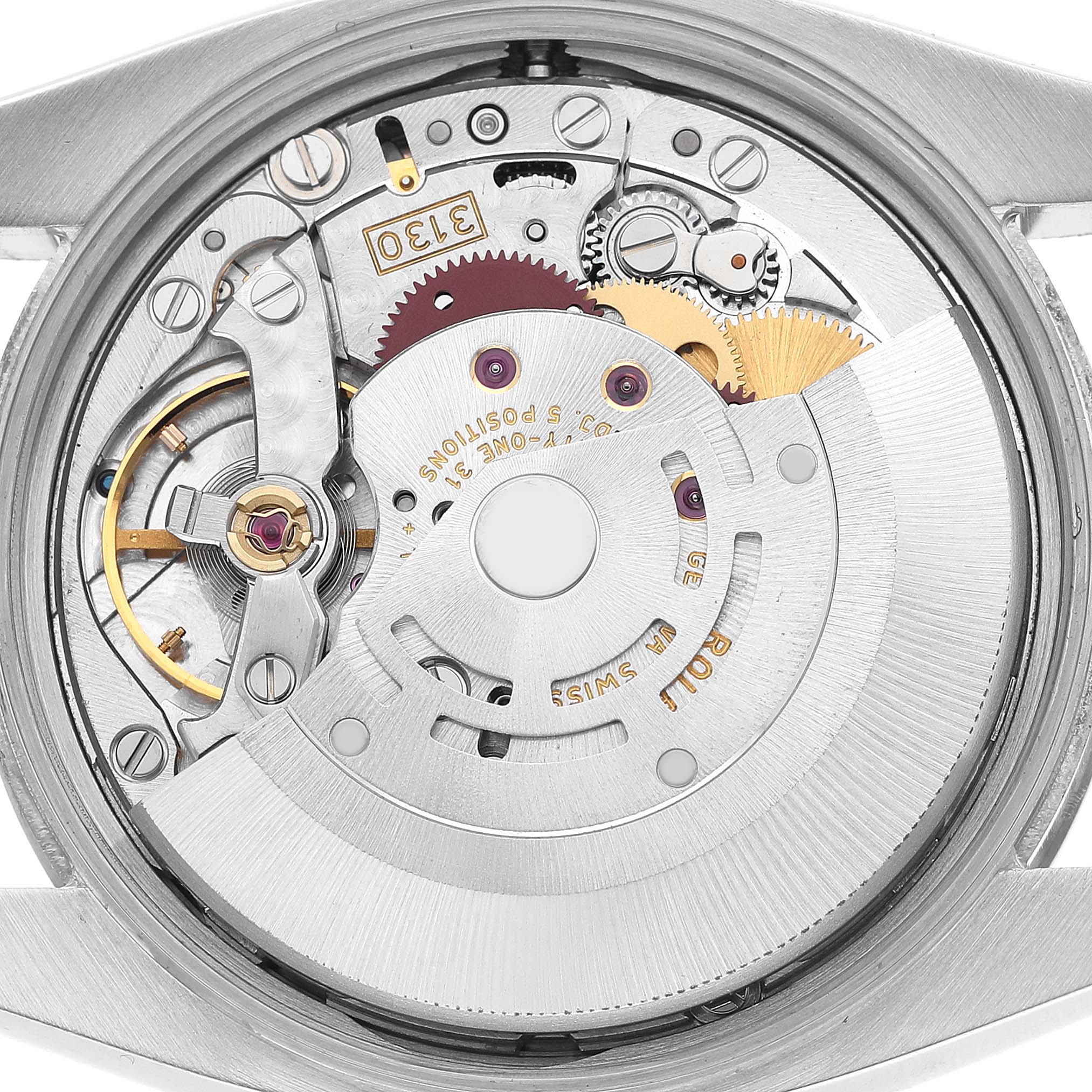 The image shows a close-up of the movement inside a Rolex Air-King 114234 Men's Stainless Steel Pink Dial watch, highlighting gears and mechanical components.