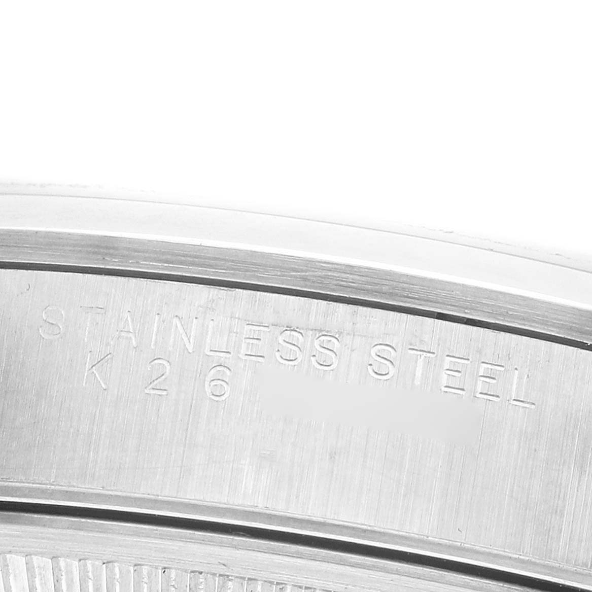 The image shows a close-up of the engraved stainless steel case back of the Rolex Date 15200 Men's Stainless Steel Silver Dial model.