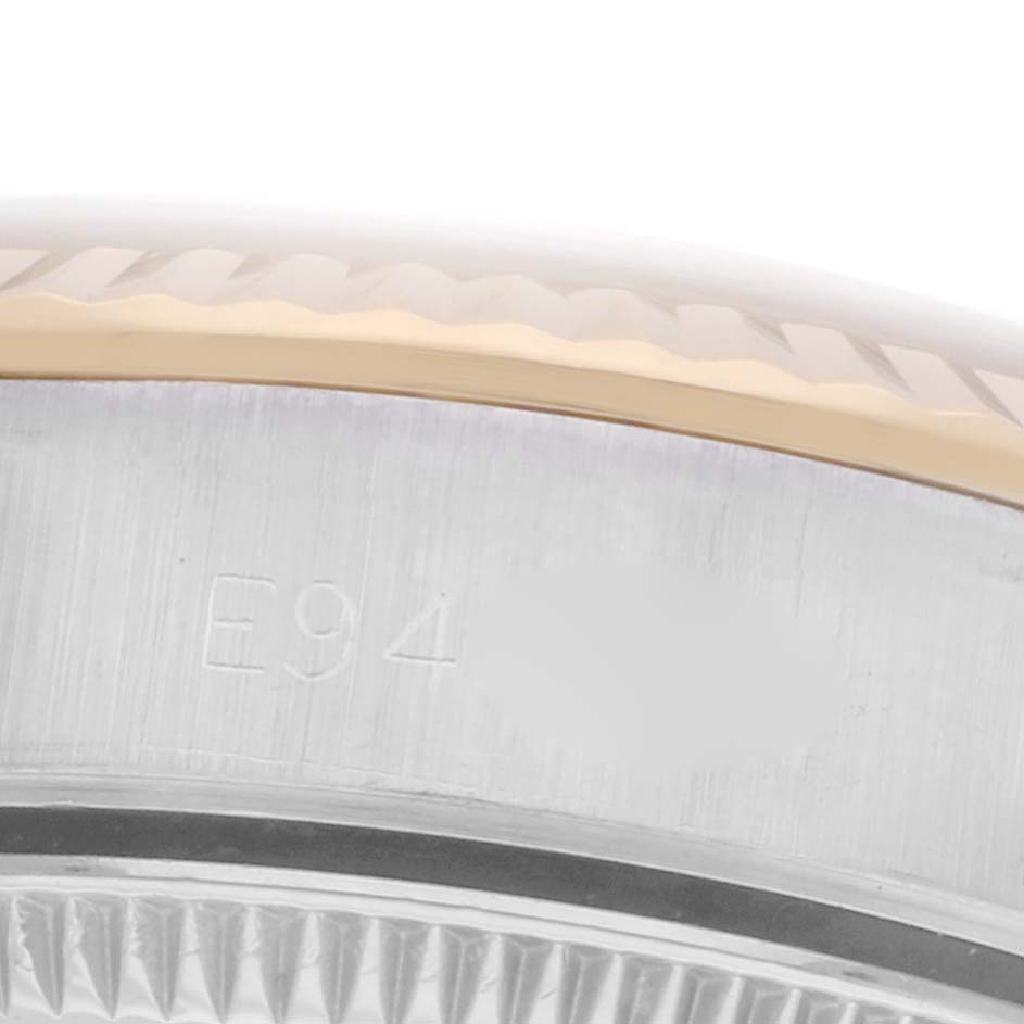 The image shows a close-up angle of the side of a Rolex Oyster Perpetual 67193 Women's Steel and Gold (two tone) Champagne Dial 67193 Women's Steel and Gold (two tone) Champagne Dial, focusing on the bezel and case edge.