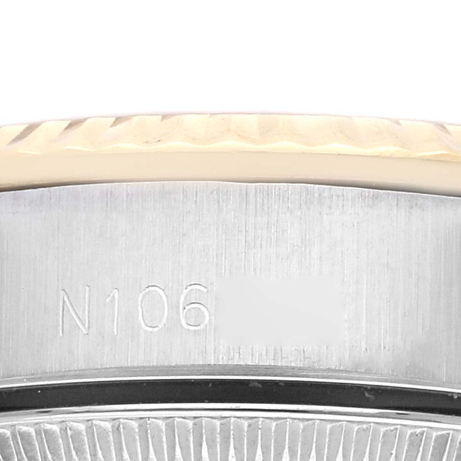 The image shows a close-up of the side of the Rolex Oyster Perpetual 67193 Women's Steel and Gold (two tone) Champagne Dial 67193 Women's Steel and Gold (two tone) Champagne Dial, highlighting the bezel and engraved edge.