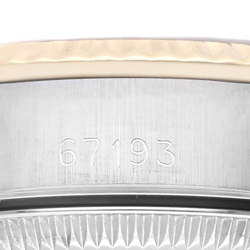 The image shows a close-up of the side of a Rolex Oyster Perpetual 67193 Women's Steel and Gold (two tone) Champagne Dial 67193 Women's Steel and Gold (two tone) Champagne Dial watch, focusing on the case and engraved model number.