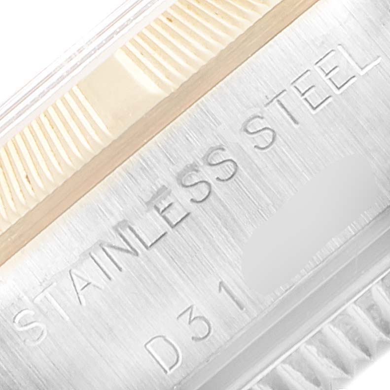 The image shows a close-up of the stainless steel casing of a Rolex Oyster Perpetual 76233 Women's Steel and Gold (two tone) Black Dial 76233 Women's Steel and Gold (two tone) Black Dial watch, focusing on the engraving detail.