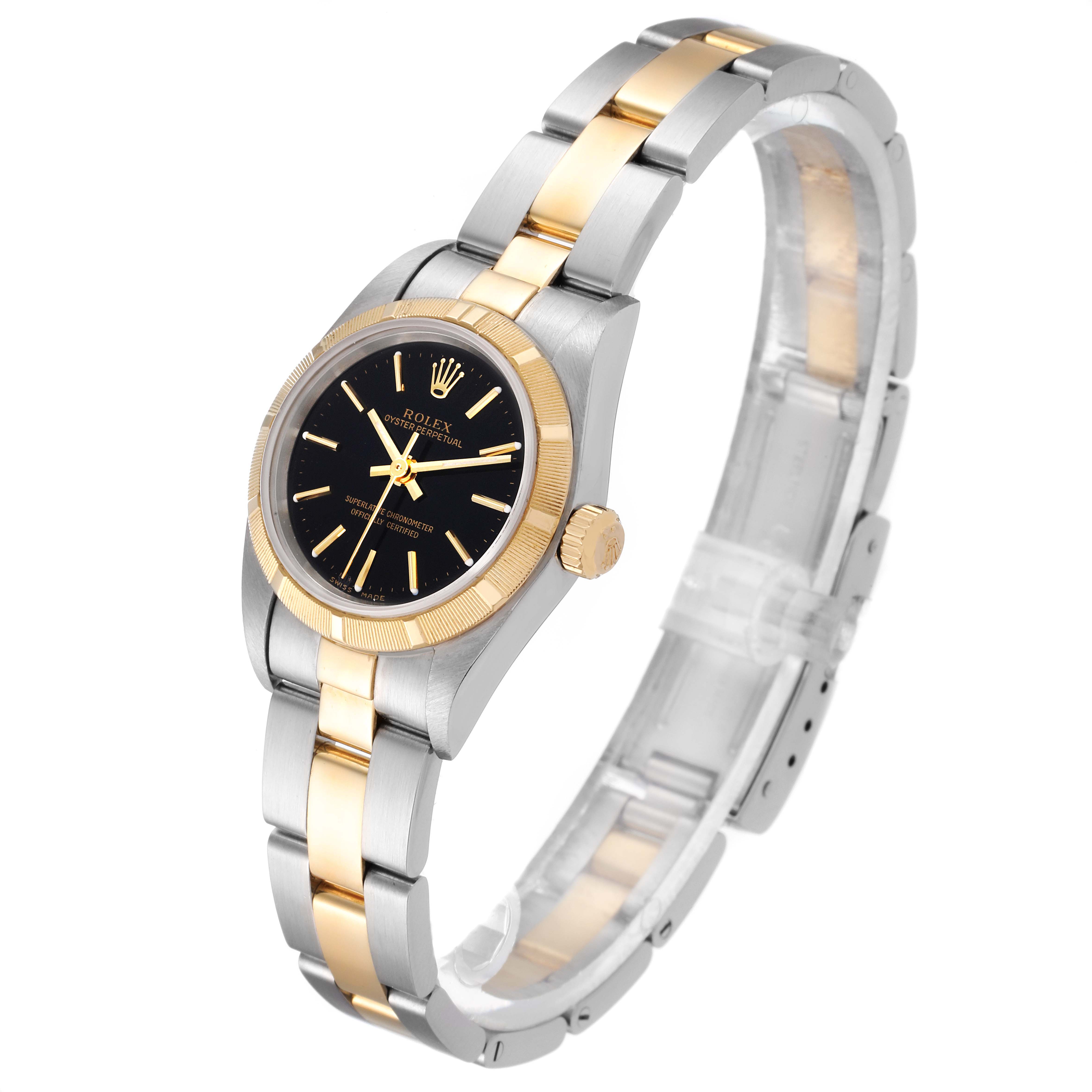 The Rolex Oyster Perpetual 76233 Women's Steel and Gold (two tone) Black Dial 76233 Women's Steel and Gold (two tone) Black Dial watch is shown at a side angle, highlighting its black dial, gold bezel, and two-tone bracelet.