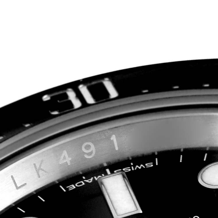 This image shows a close-up of the bezel and part of the dial of a Rolex Sea-Dweller 126600 Men
s Stainless Steel Black Dial 126600 Men
s Stainless Steel Black Dial watch.