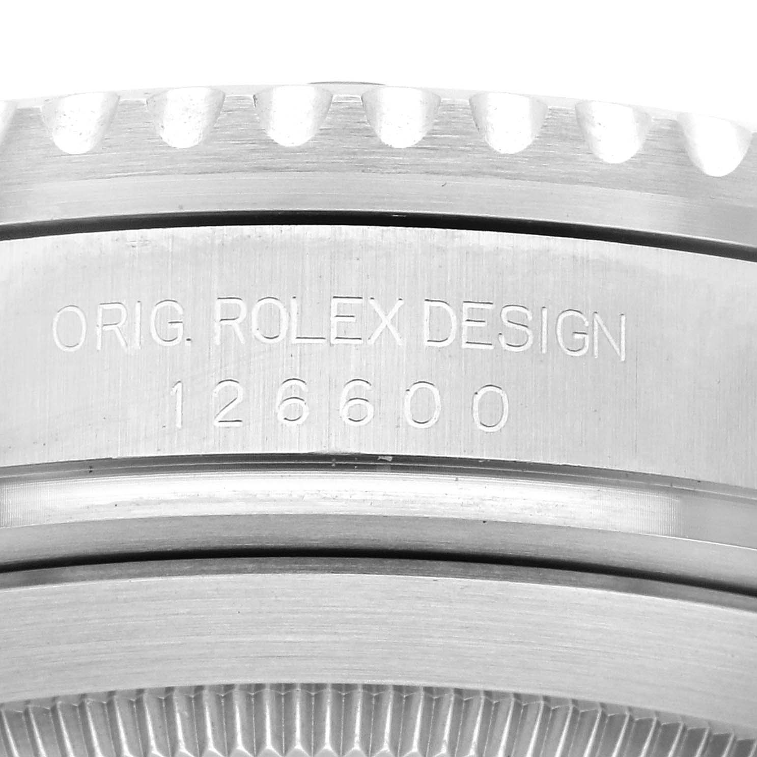 The image shows a close-up of the engraved side of a Rolex Sea-Dweller 126600 Men
s Stainless Steel Black Dial 126600 Men
s Stainless Steel Black Dial case, displaying the model number 126600.