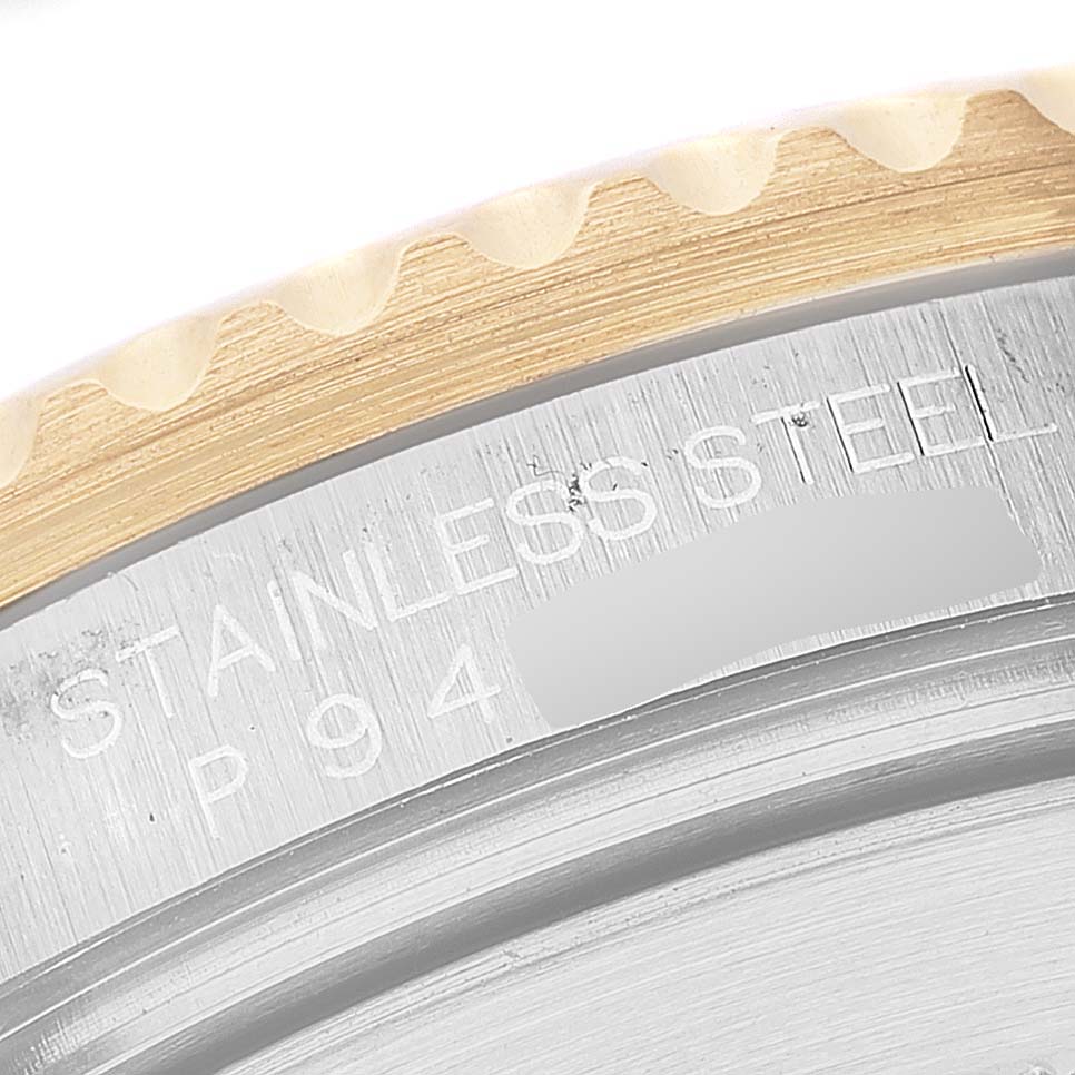 The image shows a close-up of the edge of the bezel and engraved text on the casing of the Rolex Submariner 16613 Men's Steel and Gold (two tone) Blue Dial 16613 Men's Steel and Gold (two tone) Blue Dial watch.