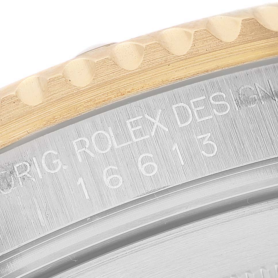 This image shows a close-up of the case back of a Rolex Submariner 16613 Men's Steel and Gold (two tone) Blue Dial 16613 Men's Steel and Gold (two tone) Blue Dial watch, highlighting the model number and part of the bezel.