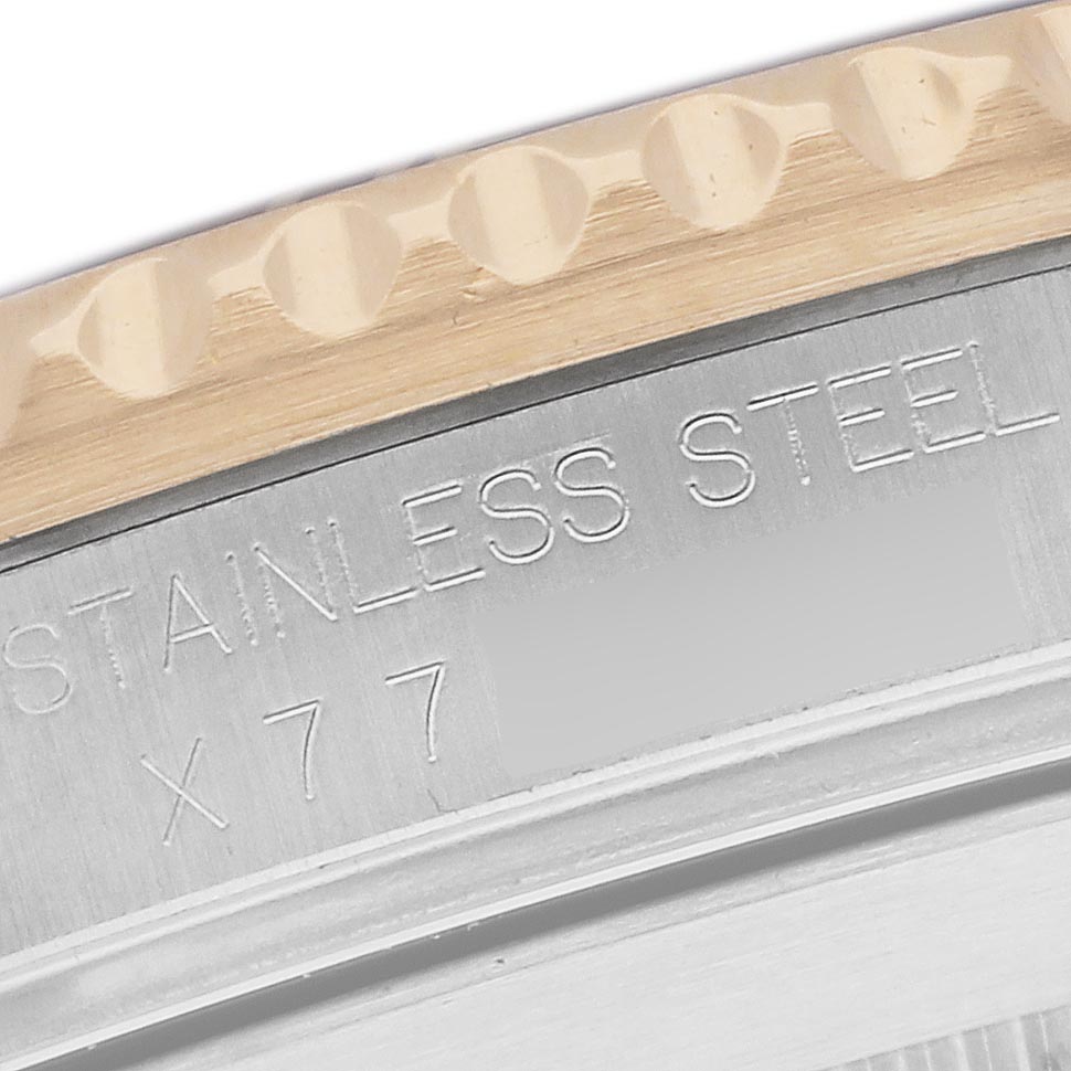 The image shows a close-up of the engraved edge and side of the bezel on a Rolex Submariner 16613 Men's Steel and Gold (two tone) Black Dial 16613 Men's Steel and Gold (two tone) Black Dial watch.