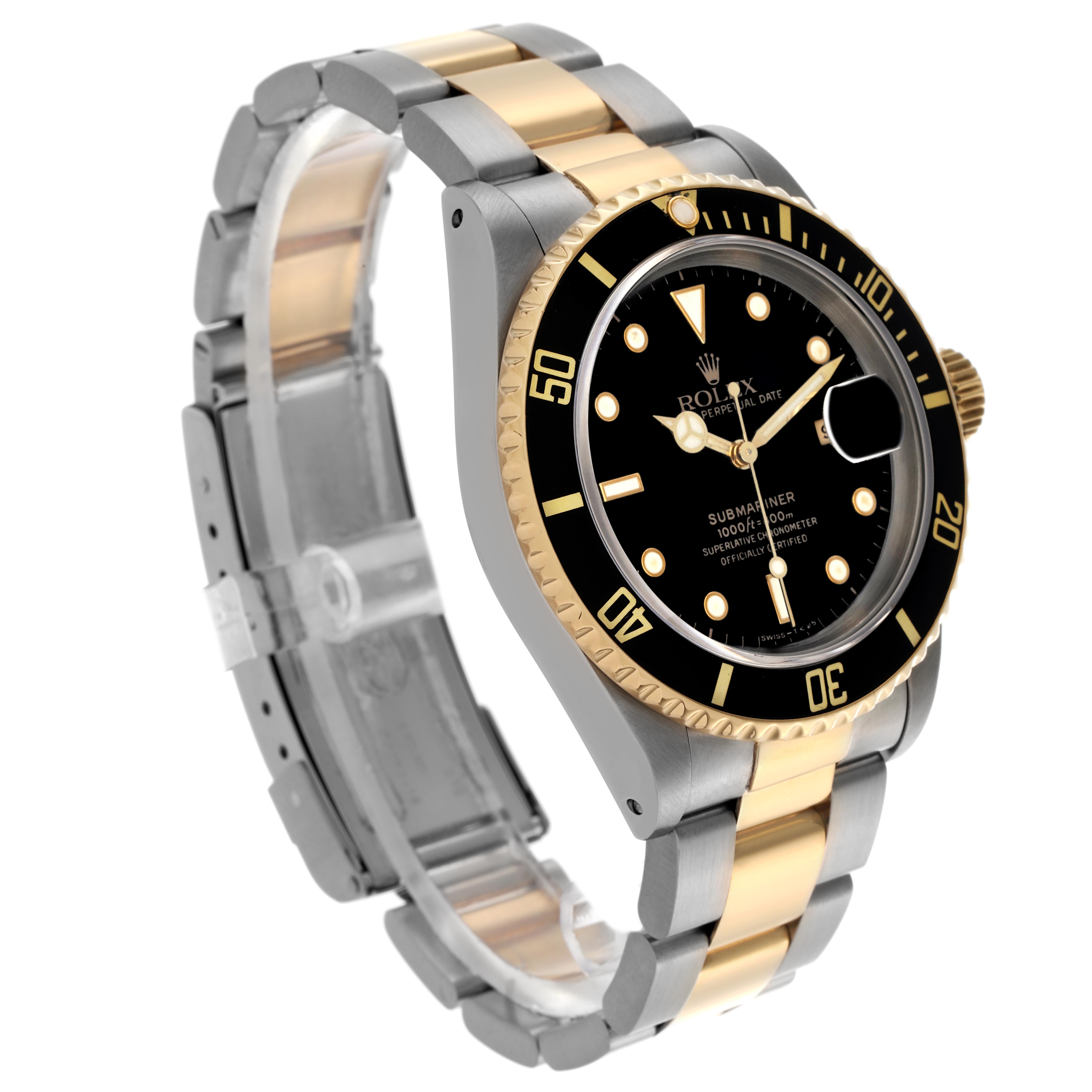 The Rolex Submariner 16613 Men's Steel and Gold (two tone) Black Dial 16613 Men's Steel and Gold (two tone) Black Dial watch is shown at a three-quarter angle, displaying the black dial, bezel, and two-tone bracelet.