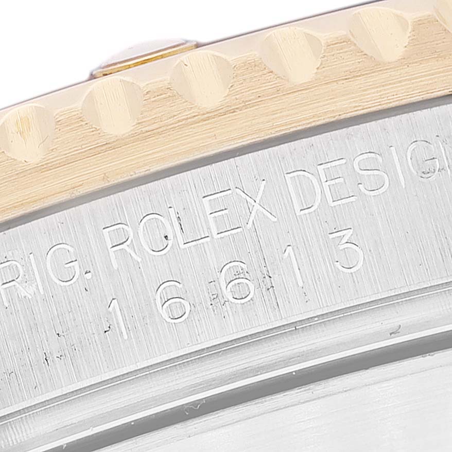 The image shows a close-up of the case side and bezel of a Rolex Submariner 16613 Men's Steel and Gold (two tone) Champagne Dial 16613 Men's Steel and Gold (two tone) Champagne Dial, revealing part of its model number engraving.