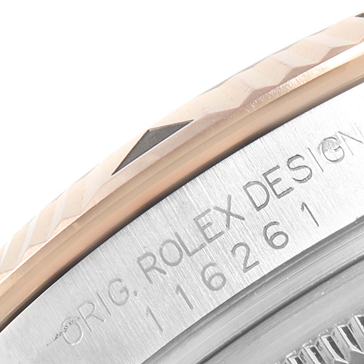 This image shows a close-up of the bezel and part of the case of a Turn-o-Graph model by Rolex, highlighting the engraved design and serial numbers.