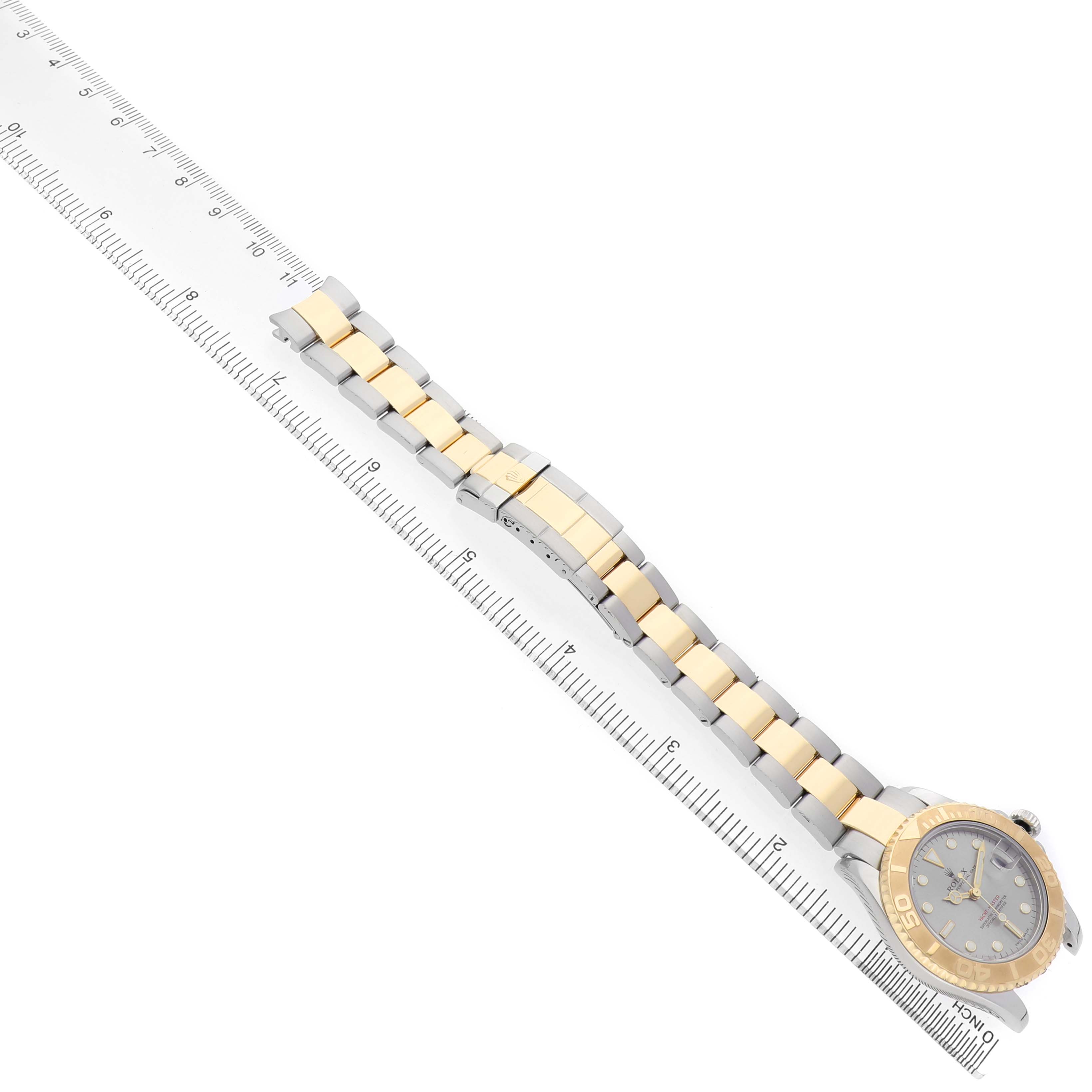 The Rolex Yacht-Master 168623 Men's Steel and Gold (two tone) Grey Dial watch is shown from a top-down angle, displaying the face, bezel, and two-tone bracelet against a ruler.