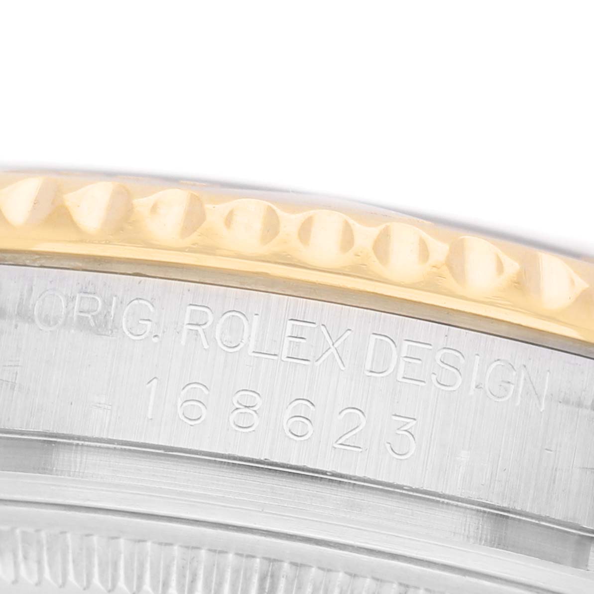 The image shows a close-up of the side of a Rolex Yacht-Master 168623 Men's Steel and Gold (two tone) Grey Dial watch, highlighting the engravings and the gold bezel.