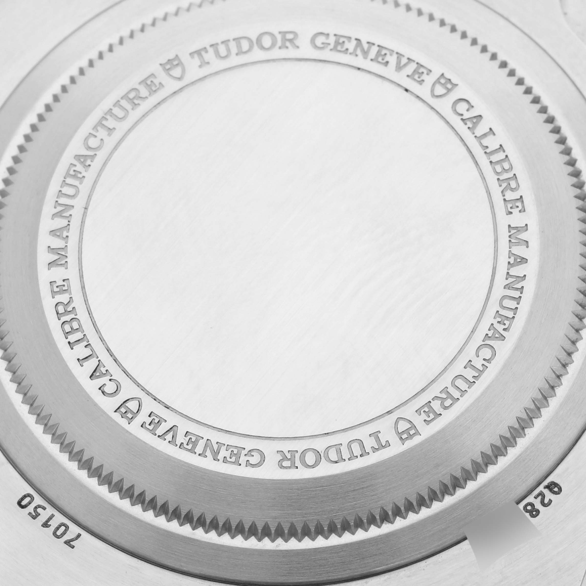 The image shows the case back of a Tudor Heritage Black Bay 70150 Men's Stainless Steel Black Dial 70150 Men's Stainless Steel Black Dial watch, highlighting engraved details and model information.