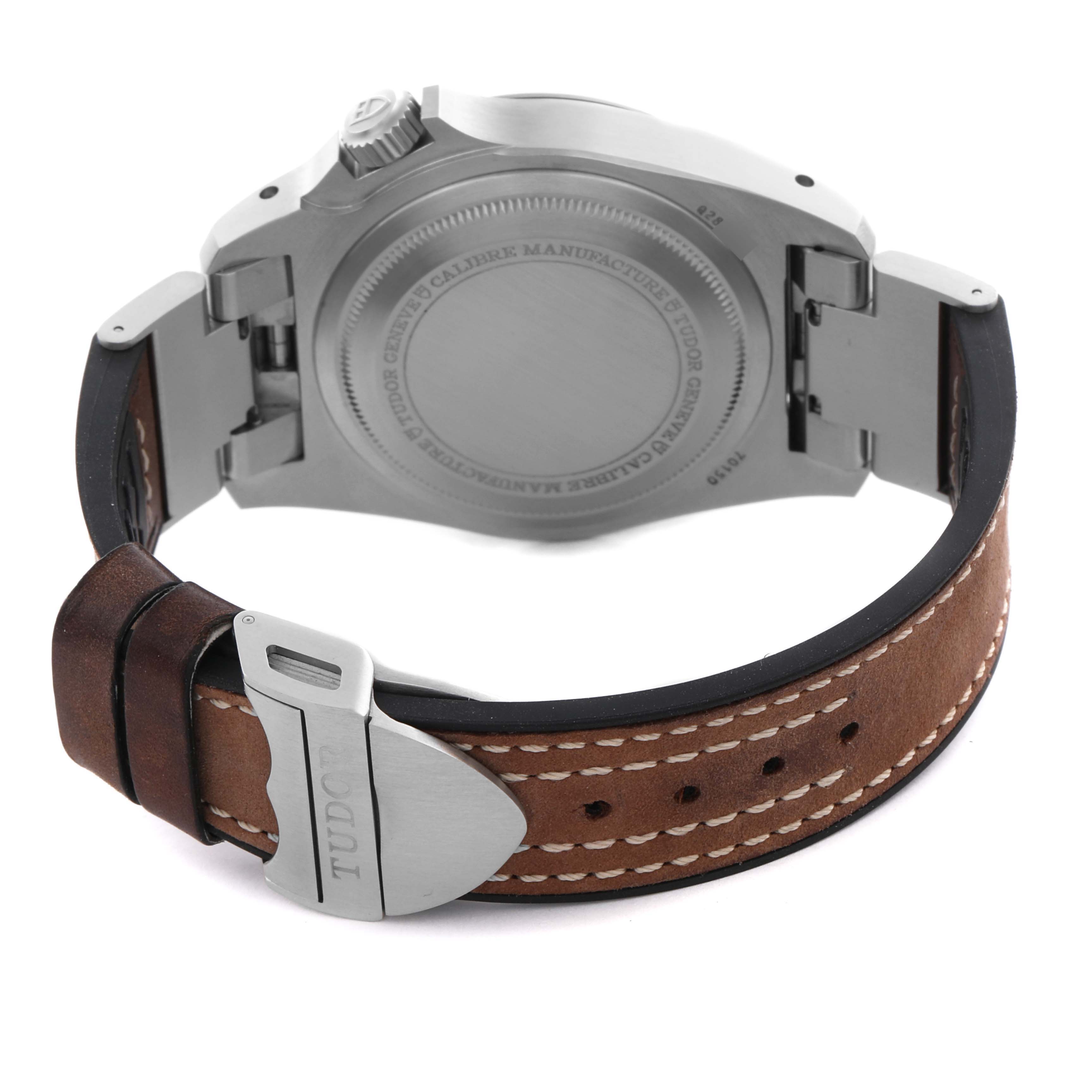 The image shows the back and side of the Tudor Heritage Black Bay 70150 Men's Stainless Steel Black Dial 70150 Men's Stainless Steel Black Dial watch, highlighting the case back, clasp, and leather strap.