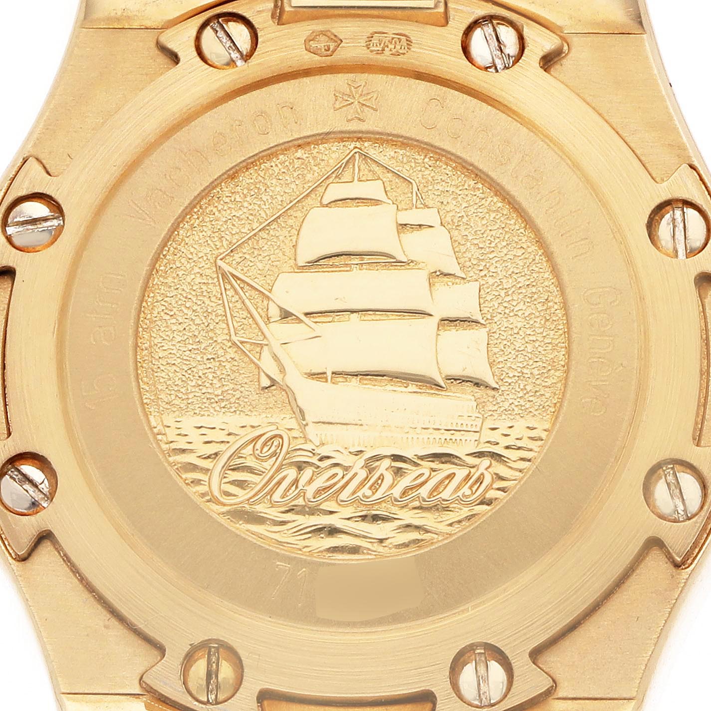 The image shows the case back of a Vacheron Constantin Overseas 16550.423J Women's Yellow Gold Silver Dial 16550.423J Women's Yellow Gold Silver Dial watch, featuring a ship engraving and engraved text.