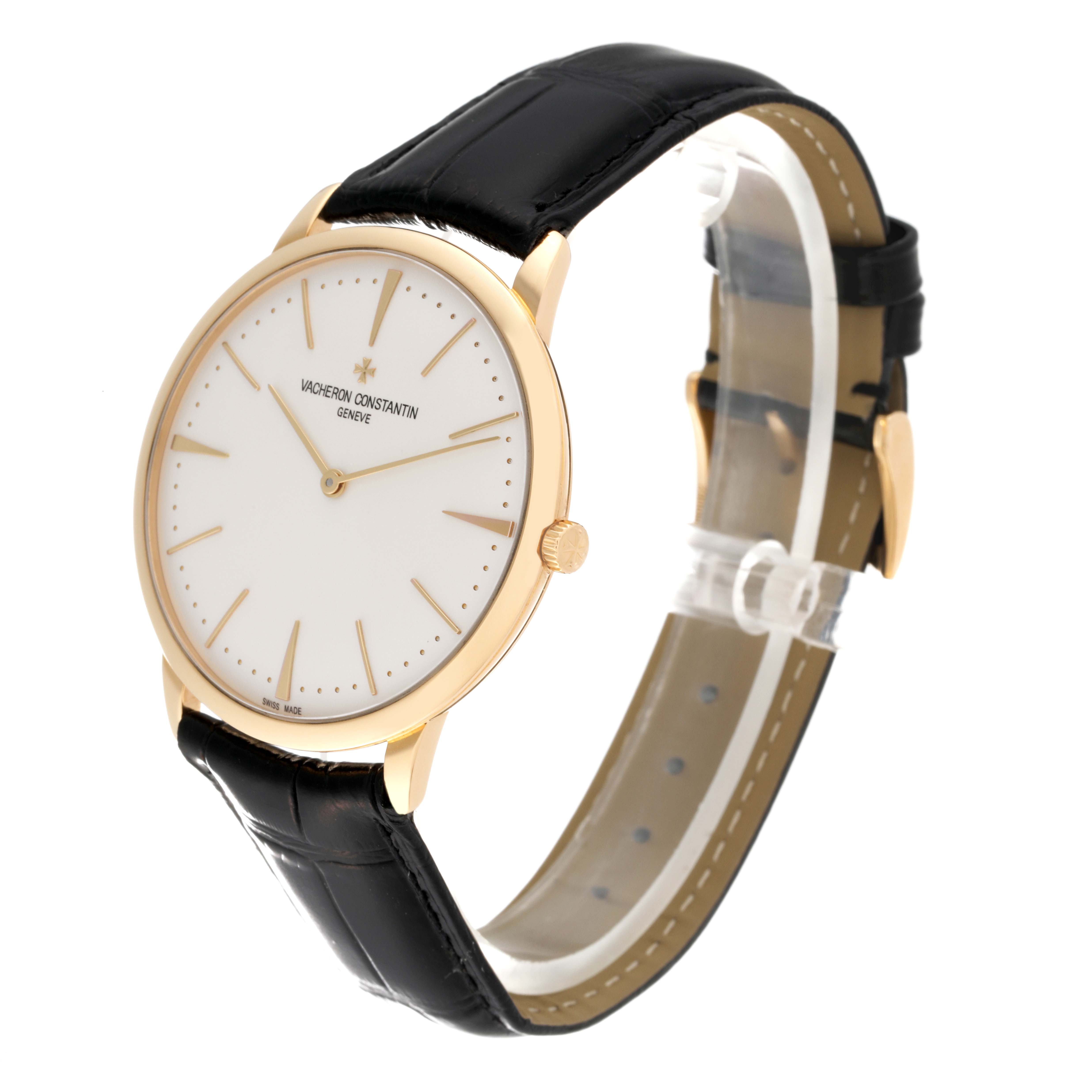 The Vacheron Constantin Patrimony 81180/000J Men's Yellow Gold Silver Dial 81180/000J Men's Yellow Gold Silver Dial watch is shown at a slight angle, displaying its face, gold case, black leather strap, and crown.